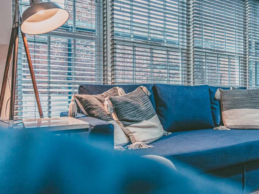 A blue linen sofa sets the tone for understated elegance in a property development by property consultants Pattison Property Group